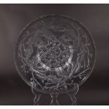 Lalique; a circular dish decorated with trees and branches, 26cm diameter.