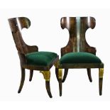 A pair of simulated walnut wingback side chairs on gilt acanthus moulded sabre supports,