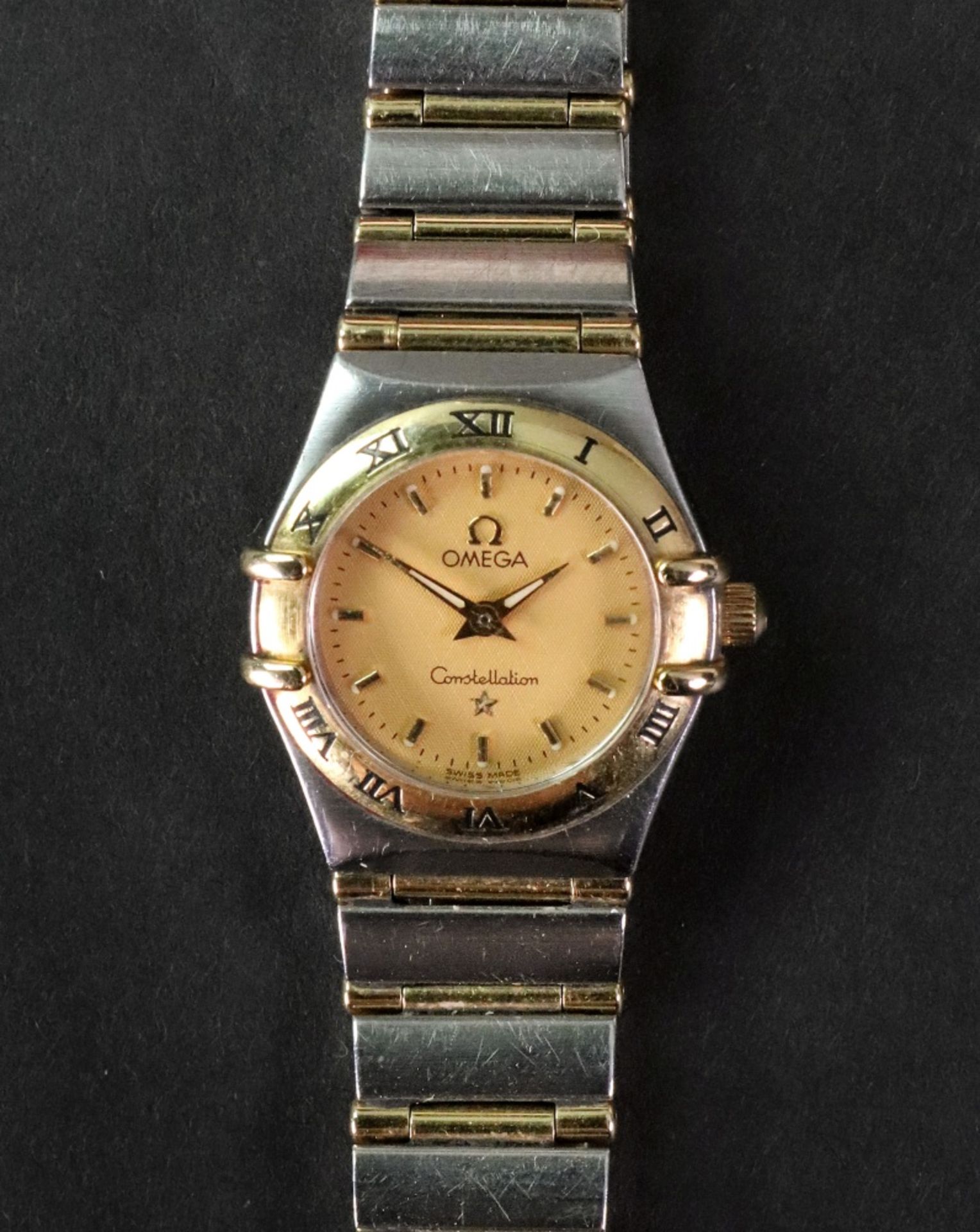 Omega, Constellation, a lady's stainless steel and gilt quartz bracelet watch, No.