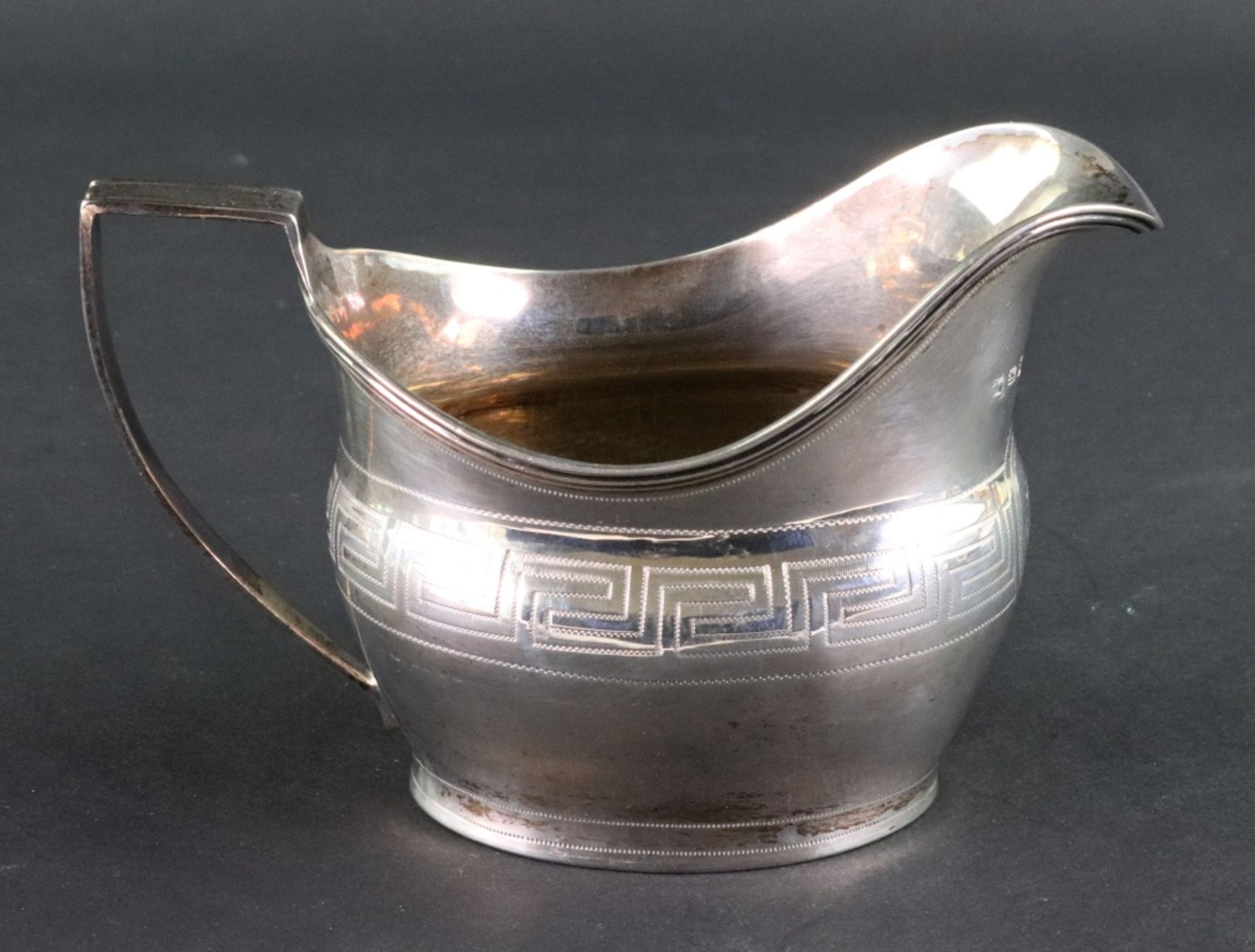 A George III silver helmet shape milk jug, London 1806, makers mark unclear,