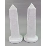 A pair of Victorian white pressed glass obelisks, decorated with hieroglyphics, 22cm high.
