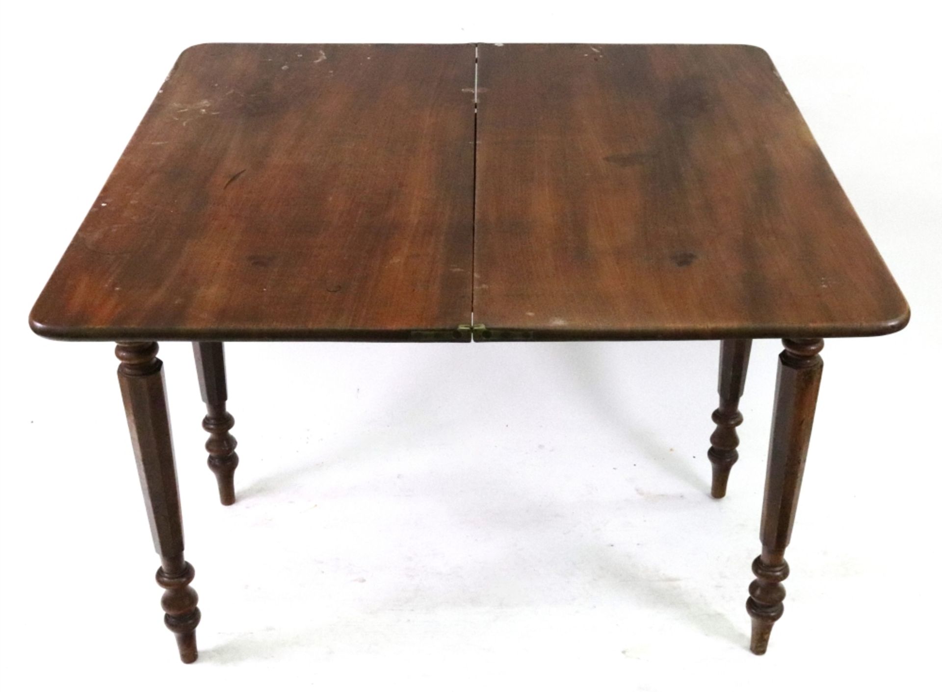 A William IV mahogany tea table, the hinged fold over top on turned and octagonal tapering legs,