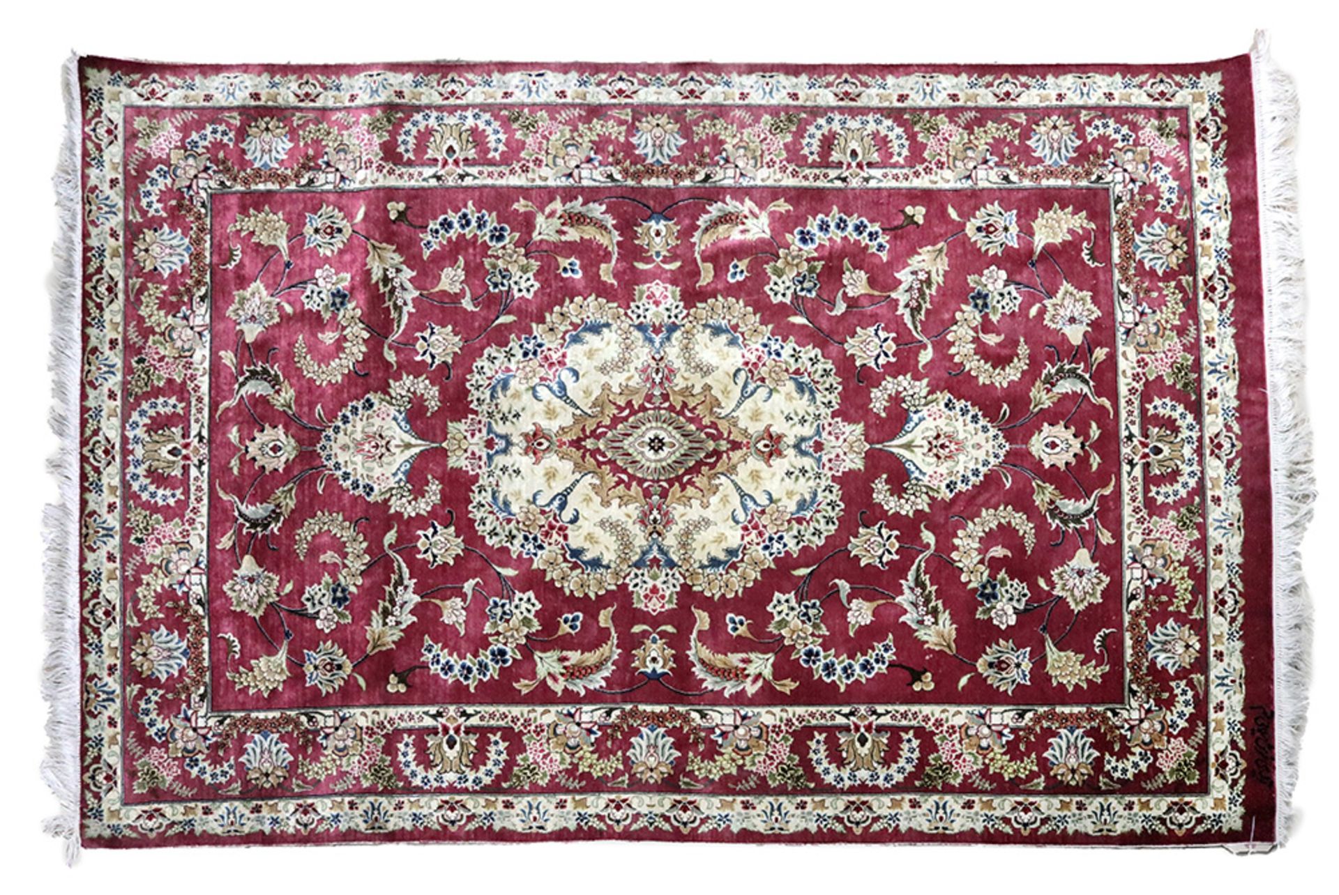 A silk rug, possibly Chinese or Indian,