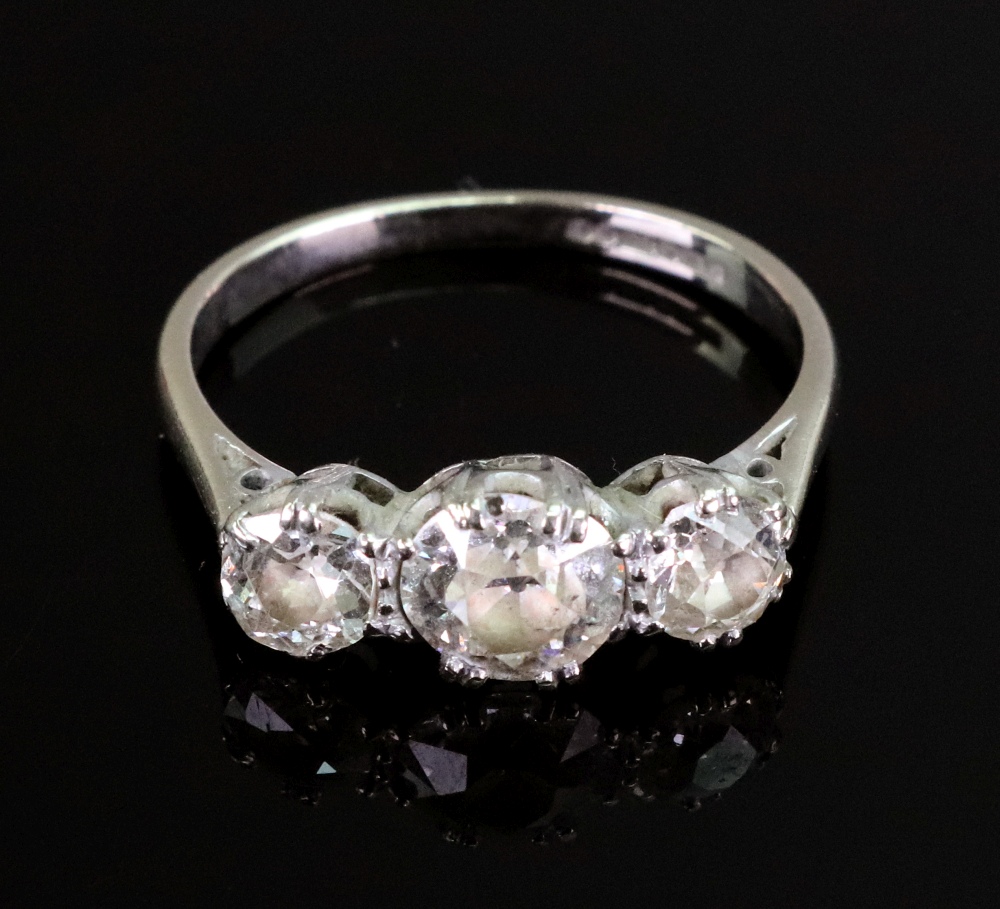 An 18ct white gold and diamond three stone ring, the graduated old-cut stone approximately 0.