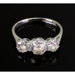 An 18ct white gold and diamond three stone ring, the graduated old-cut stone approximately 0.
