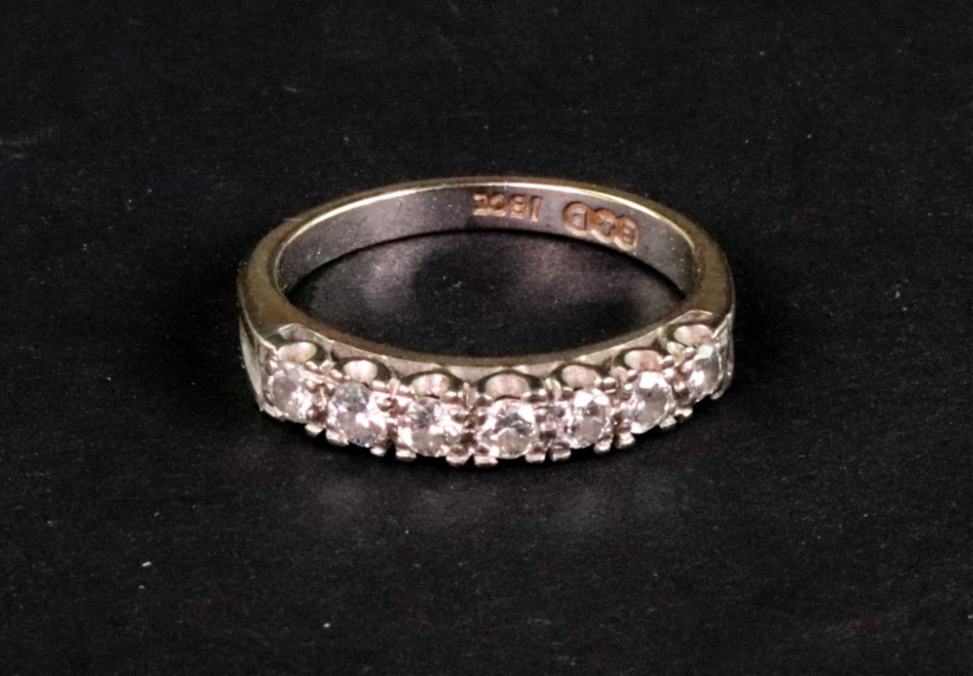 A Boodle and Dunthorne diamond half-eternity ring, the seven round brilliants approximately 0.