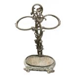 A late Victorian green patinated cast iron stick stand, of shaped outline,