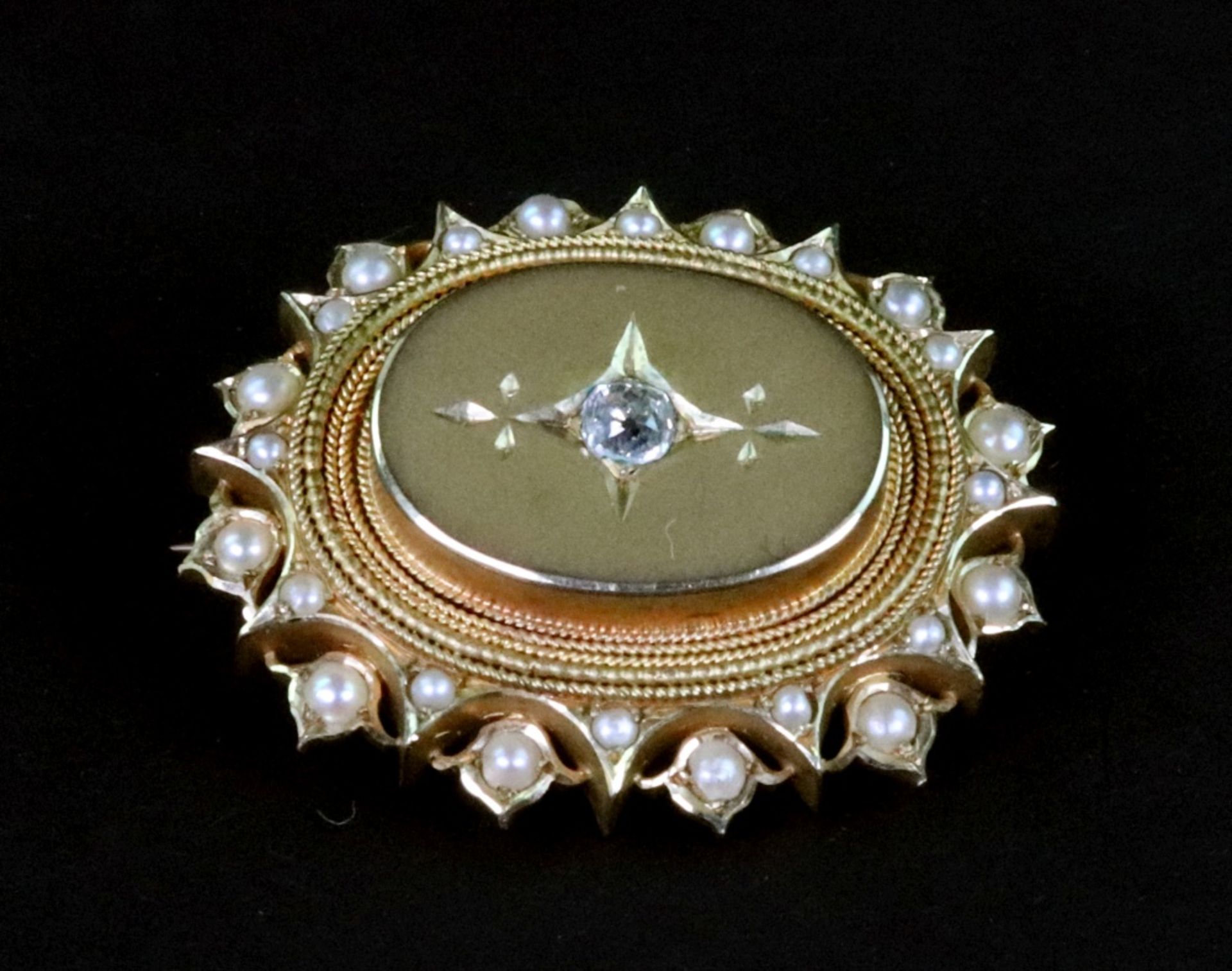 A Victorian gilt-metal, half-pearl and small old-cut diamond oval brooch, approximately 33mm wide,