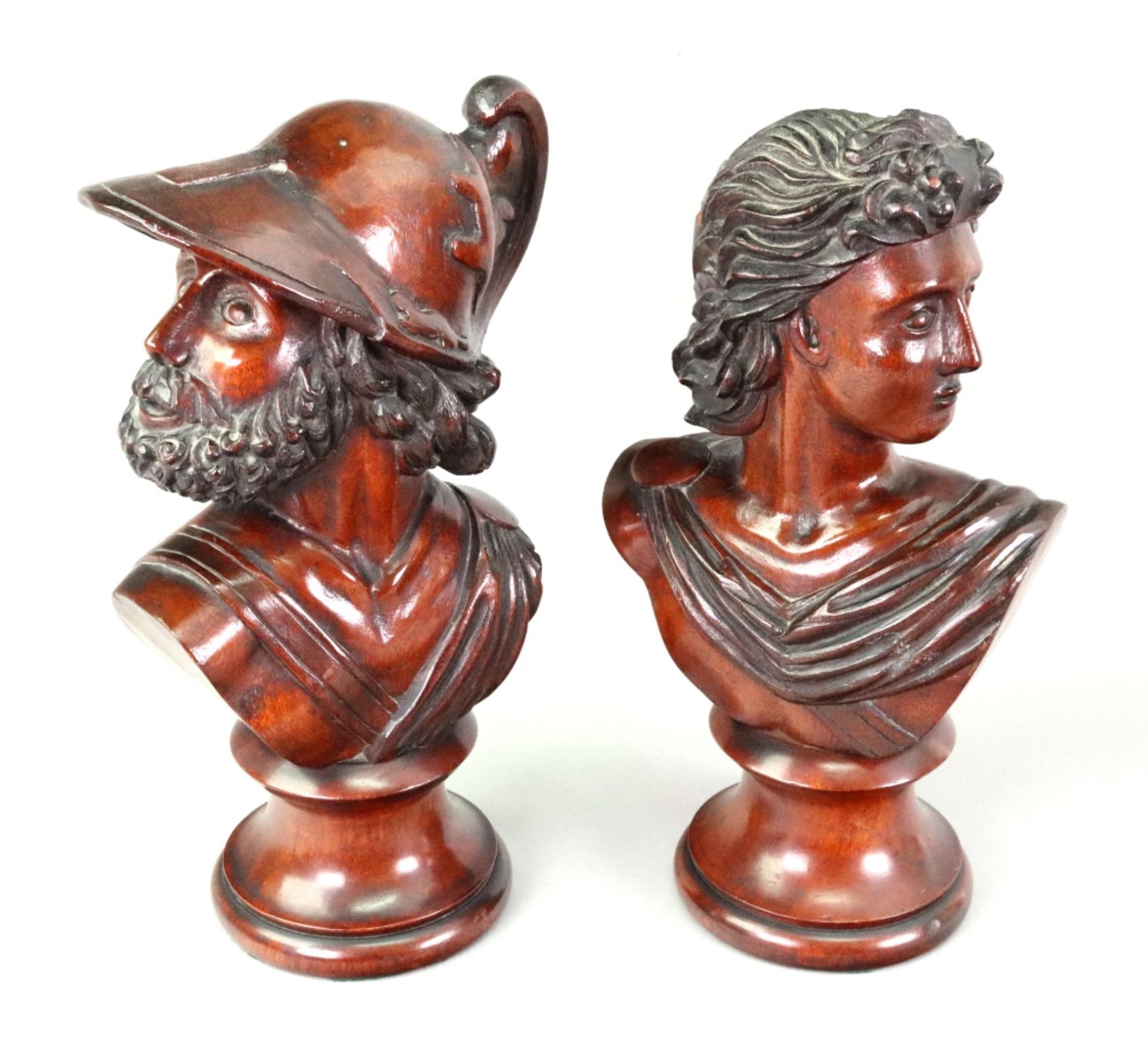 A pair of carved mahogany classical male portrait busts, after the antique, on socles, 28cm high.