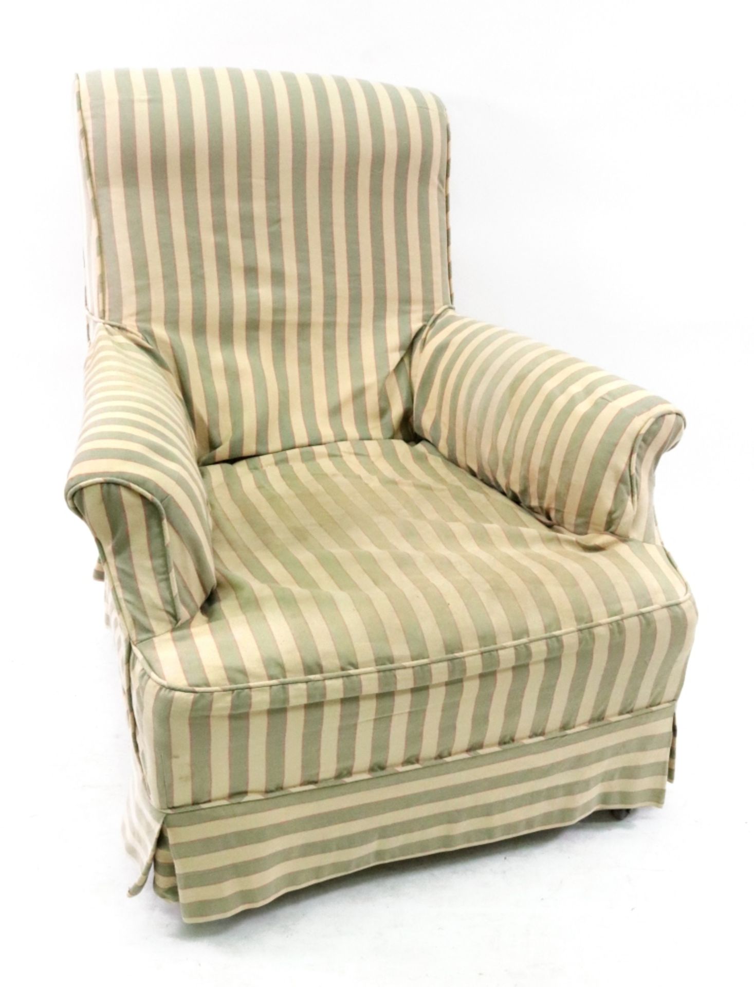 A late Victorian upholstered armchair, on turned mahogany legs and castors,