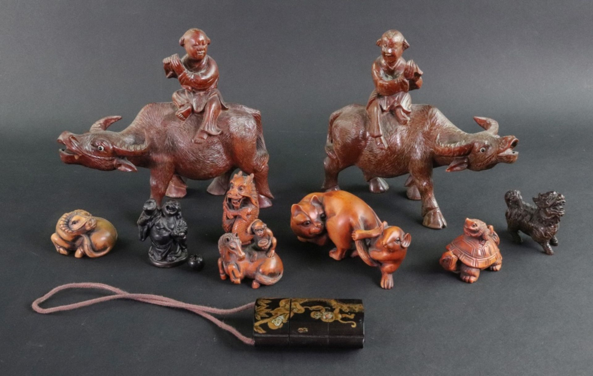 A collection of seven Japanese carved wood netsuke, 20th century, to include a frog on a tortoise,
