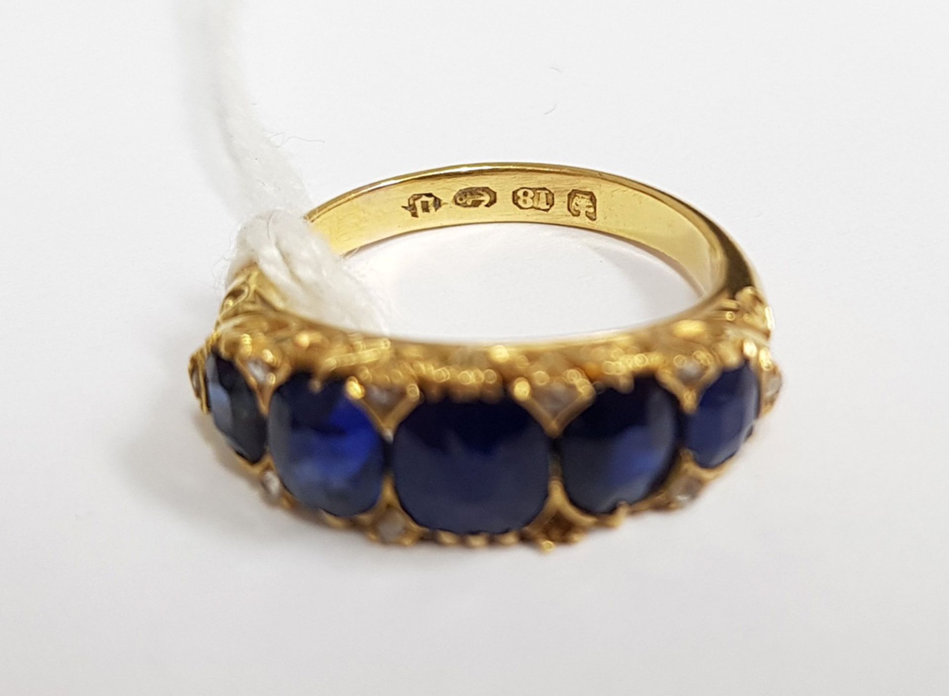 A late Victorian gold and sapphire five stone carved half-hoop ring with rose diamond points, - Image 4 of 5