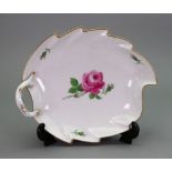 A Meissen leaf shape dish, 20th century, painted with pink roses and gilded, 22cm wide.