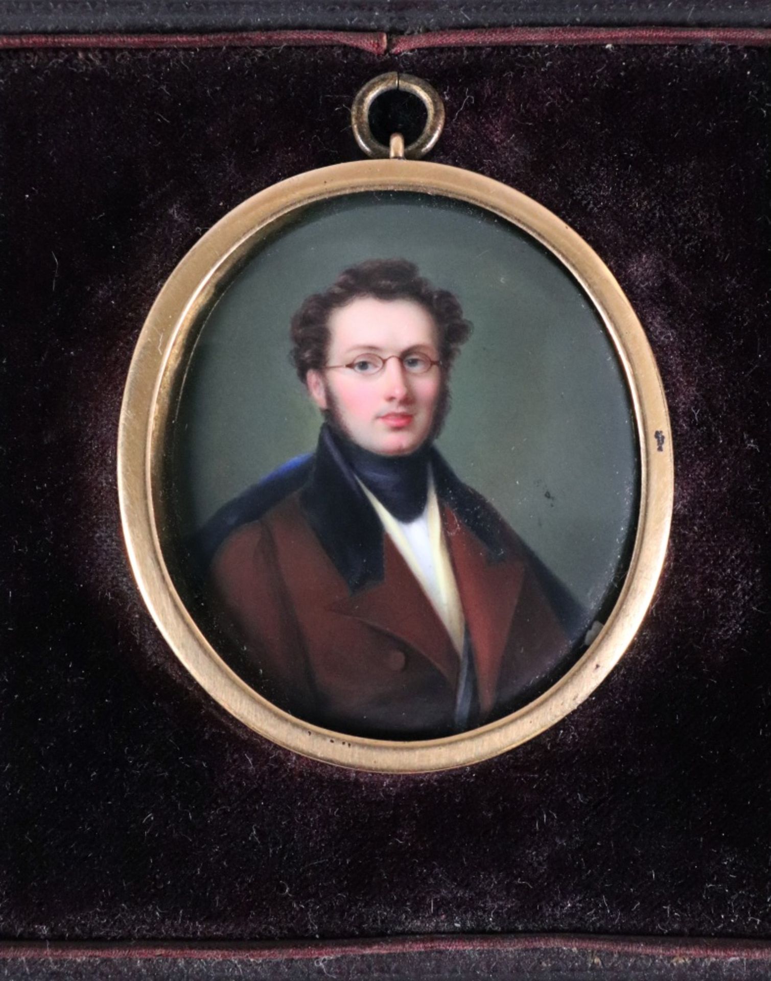 English School, 19th Century, A portrait miniature of a gentleman in a brown coat, wearing glasses,