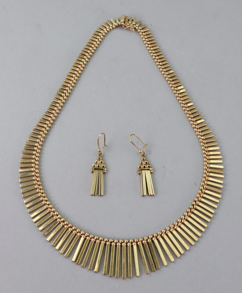 A 9ct gold fringe necklace of graduated design, the rectangular baton links below two rows of beads,