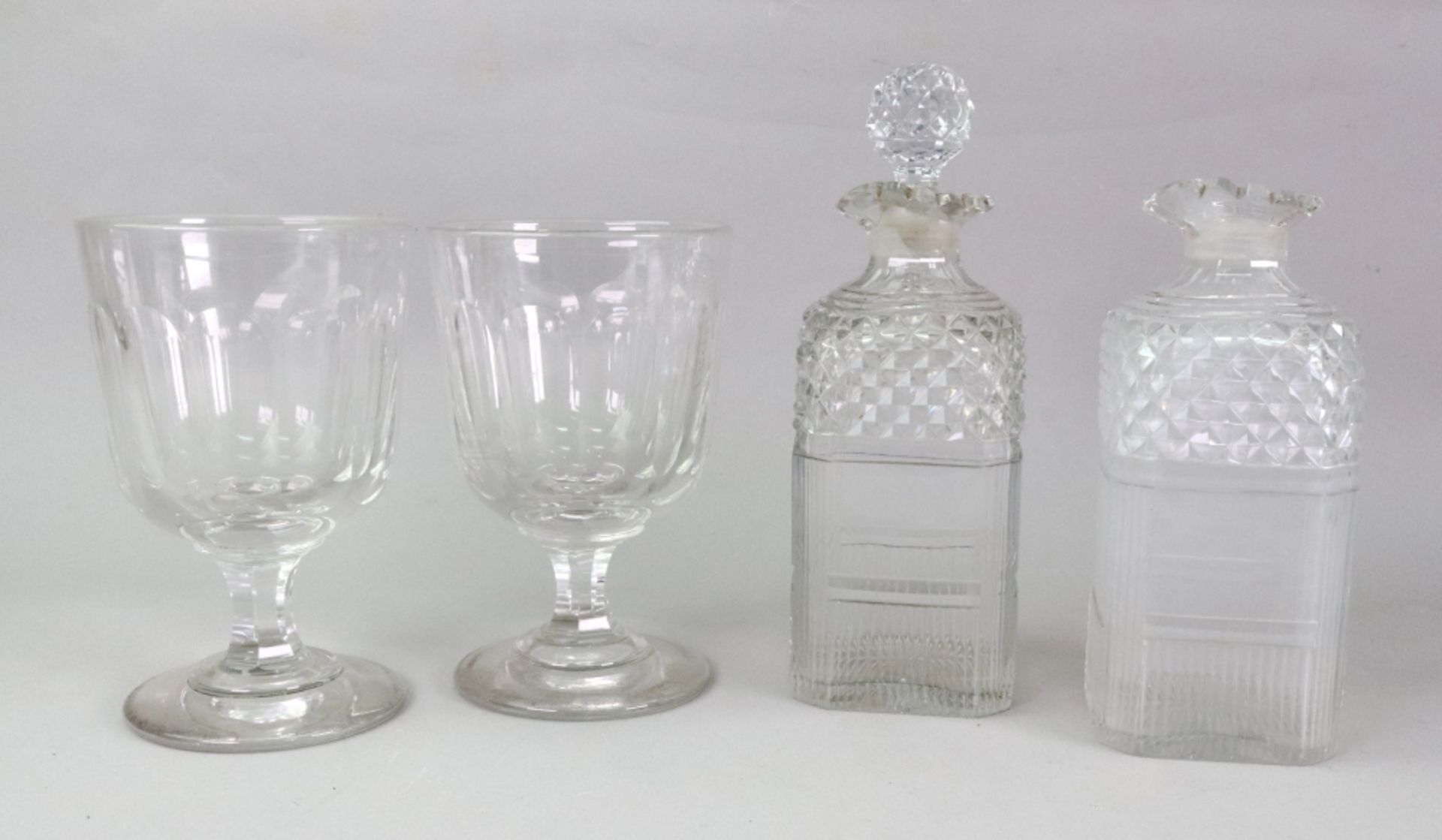 A pair of early 19th century square section glass decanters, diamond and split cut, side pouring,