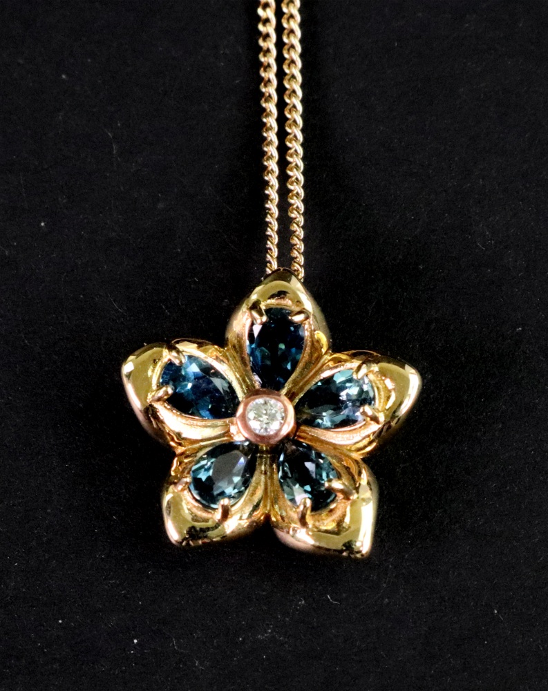 A Cloggau Welsh gold, blue topaz and diamond forget-me-not flower cluster pendant,
