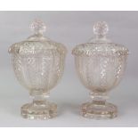 A pair of Victorian glass jars and covers of vase form, lobed and fluted diamond and facet cut,