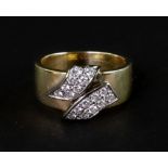 A Continental diamond cross-over scrolls broad band ring,