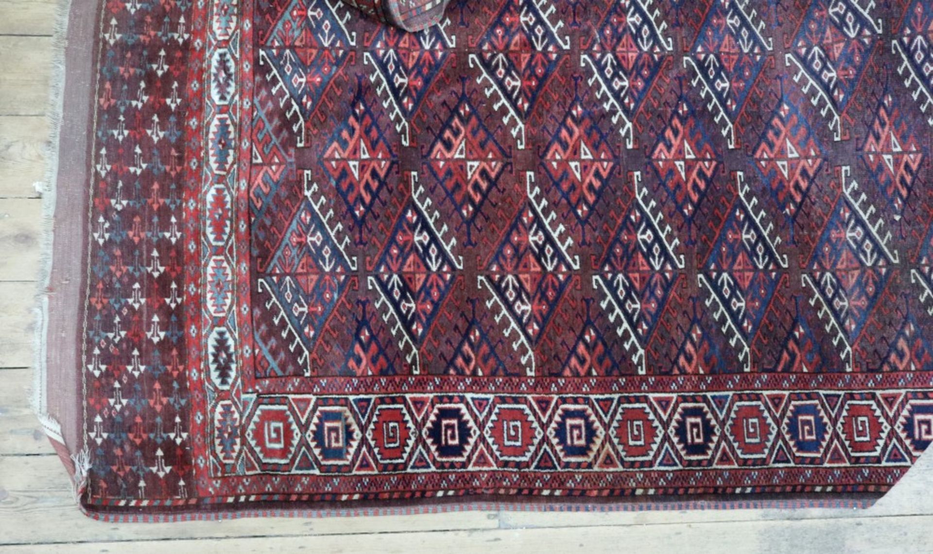 A Tekke rug, with rows of quartered lozenges, on a rust ground, 310 x 188cm.