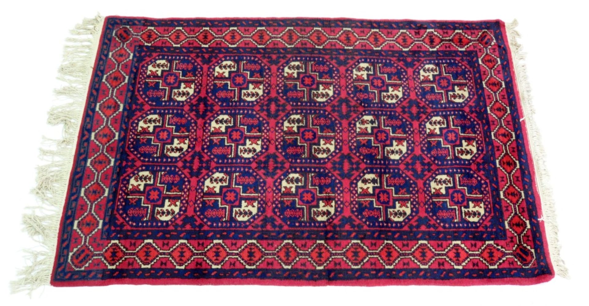 A Turkoman rug, with three rows of quartered guls, on a red field, 206 x 130cm.