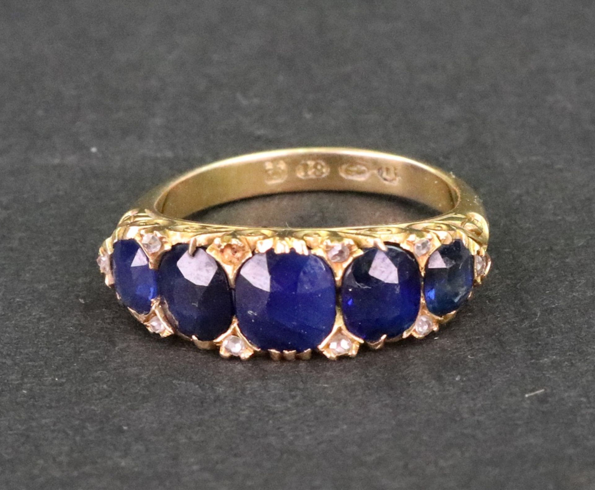 A late Victorian gold and sapphire five stone carved half-hoop ring with rose diamond points, - Image 2 of 5