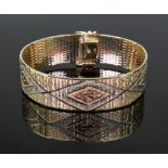 A contemporary flexible three colour 14ct gold bracelet,