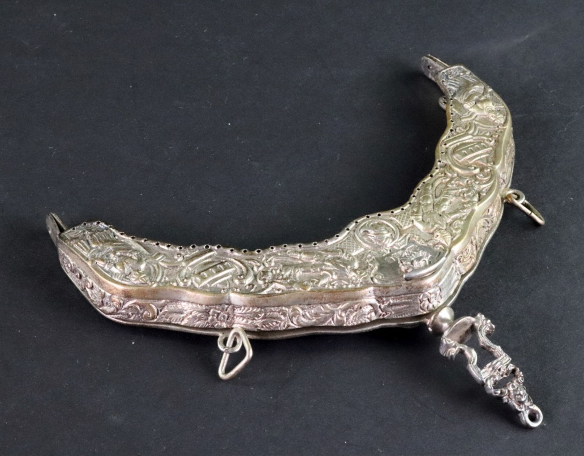 An ornate silver handbag mount, Samuel Jacob, London 1912, of arched shaped outline,