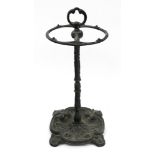 A Victorian style green painted cast iron stick stand, circular with two divisions,