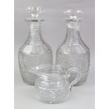 A pair of Regency diamond and split cut glass decanters, with stepped necks,