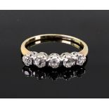 A five stone diamond ring, the claw set stones in white on a yellow gold shank, stamped '18ct',
