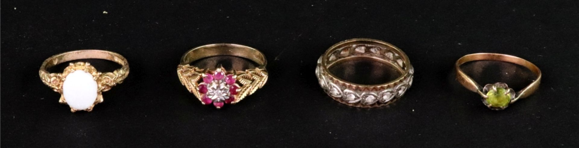 A group of four gold and gem set rings, comprising; a 9ct gold,