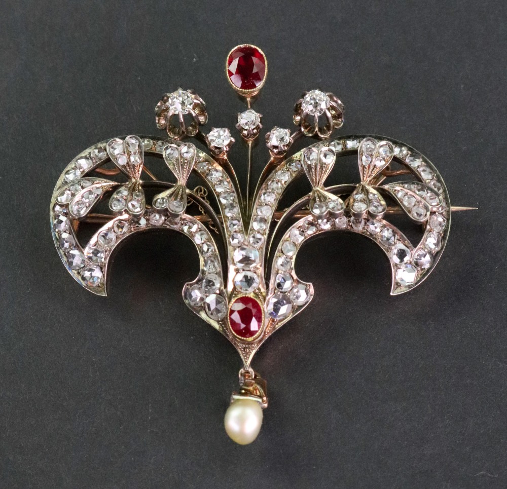 A late Victorian gold, synthetic-ruby and diamond floral double-scroll brooch,