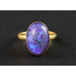 A late Victorian gold and black opal single stone ring, the oval cabochon approx.