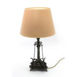 A Victorian electroplate table lamp, adapted from a tazza, hung with chains,