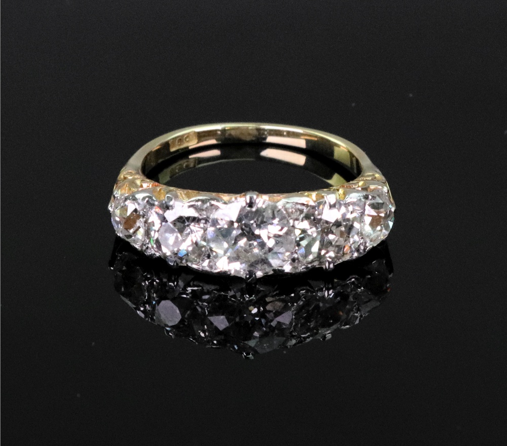 A late Victorian gold and diamond five stone carved half-hoop ring with rose diamond points,