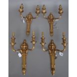 A set of four Louis XVI style gilt brass two branch wall appliques, early 20th century,