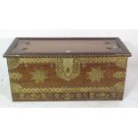 A 20th century African hardwood and brass bound studded trunk with three drawers,