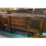 A late 19th century marble topped Spanish walnut sideboard with three central drawers flanked by