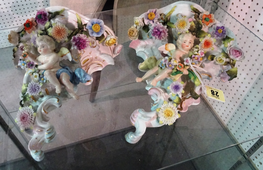 A matched pair of Continental porcelain wall brackets, one with Sitzendorf mark, early 20th century,