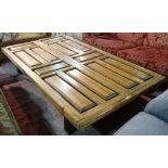 A pine coffee table, the rectangular top made from pair of eight panel doors on block supports,