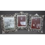 Seven Linea Argenti strutback photograph frames, each white metal with foliate pierced border,