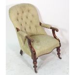 A Victorian mahogany framed open armchair with button back upholstery.