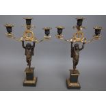A pair of French gilt and patinated bronze Empire revival figural, three branch candelabra,