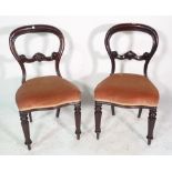 A pair of Victorian mahogany balloon back dining chairs on reeded tapering supports, (2).