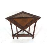 An 18th century style oak drop flap handkerchief table,on bobbin turned supports,