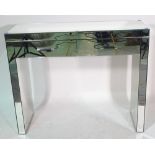 A Brighton mirrored two drawer side table, 101cm wide x 82cm high.