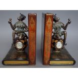 A pair of modern leather and metal mounted bookends modelled with a monkey on a globular clock and