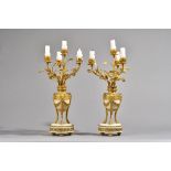 A pair of French Louis XVI style ormolu and white marble four branch candelabra,