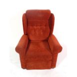 A 20th century hardwood framed wingback upholstered electric armchair.